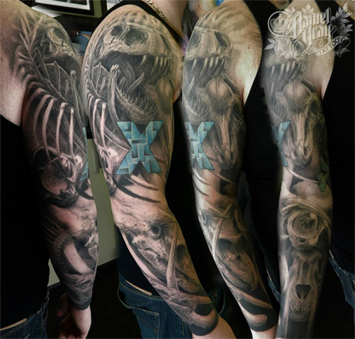 dinosaur sleeve tattoo by cincinnati artist Daniel Gray